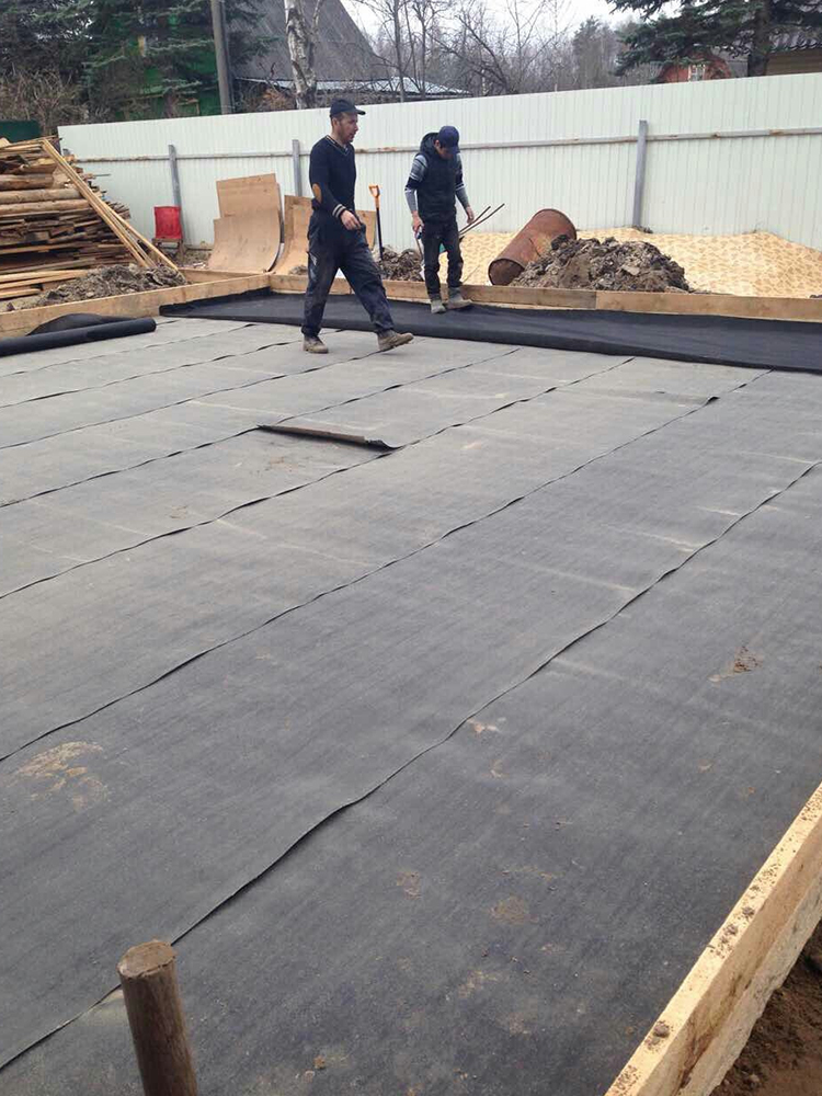 Workers performing balcony repair work on concrete floor